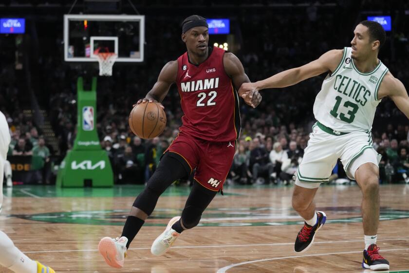 Miami Heat forward Jimmy Butler (22) drives to the basket against Boston Celtics guard Malcolm Brogdon.