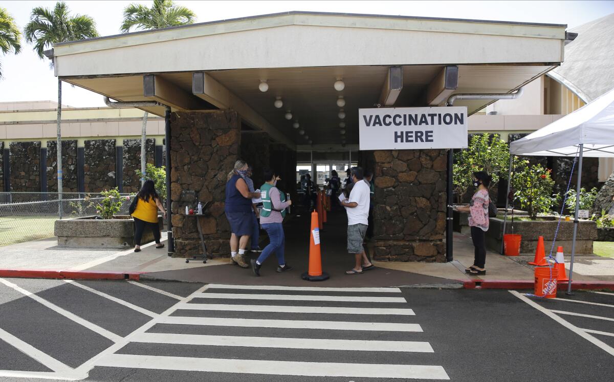 People line up to get COVID-19 vaccinations in Lihue, Hawaii, on March 3.