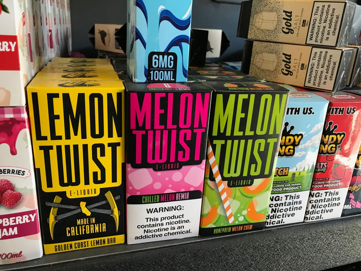 Flavored vaping products containing nicotine fill a Los Angeles store shelf in 2019. 