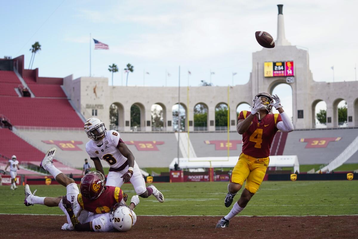 USC wide receiver Bru McCoy catches a deflected pass in the end zone for a touchdown in the Trojans' 28-27 win.