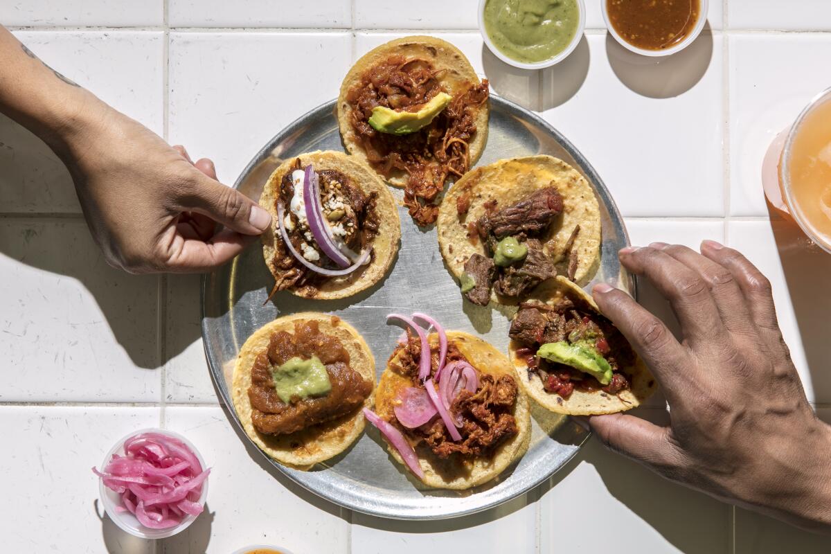 A taco sampler, and sides of salsas, at the original Guisados in Boyle Heights.