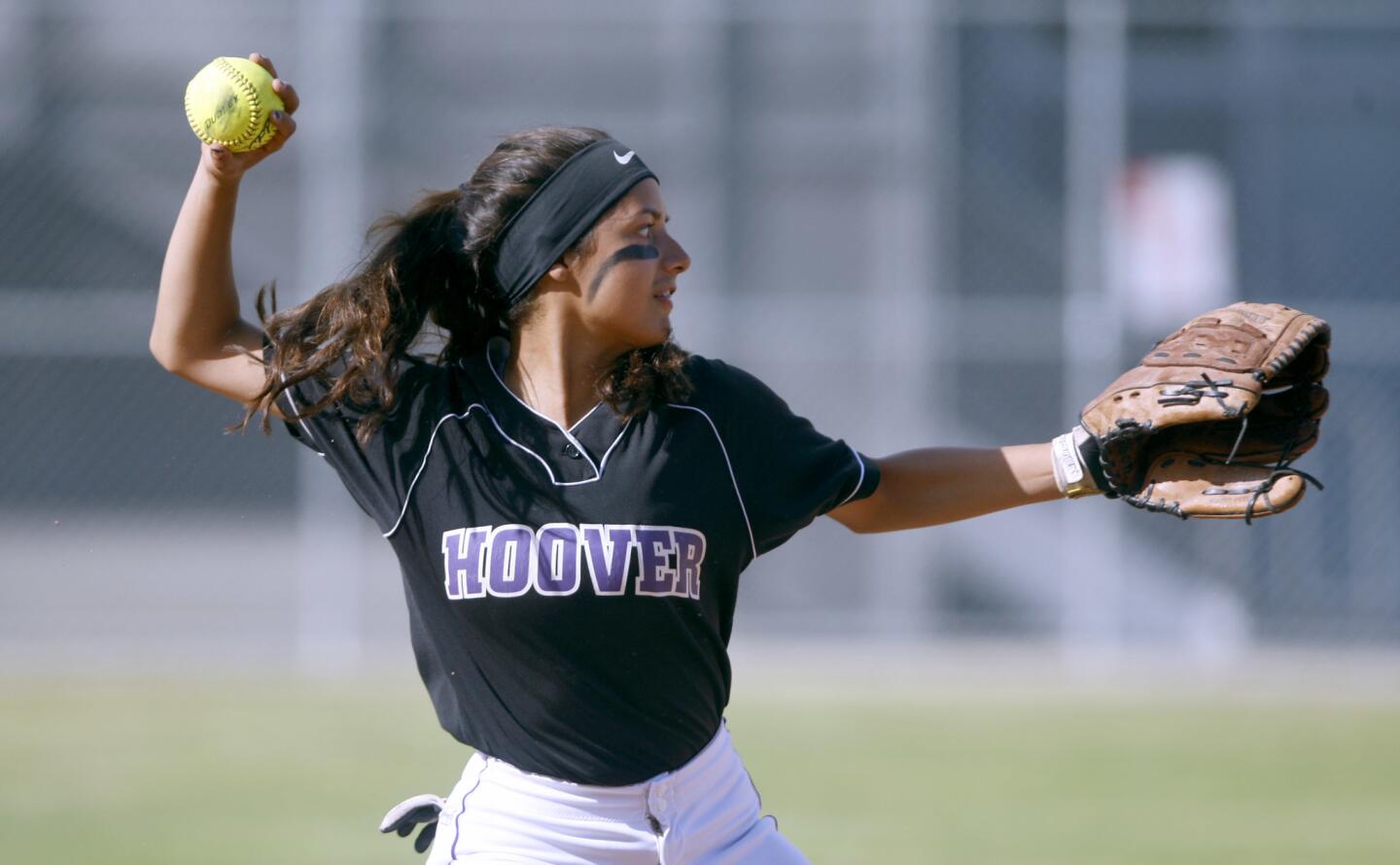 Hoover High School softball player #23 Samantha Serrano throws to first base in game vs. Burbank High School, at home in Glendale on Thursday, April 13, 2017.