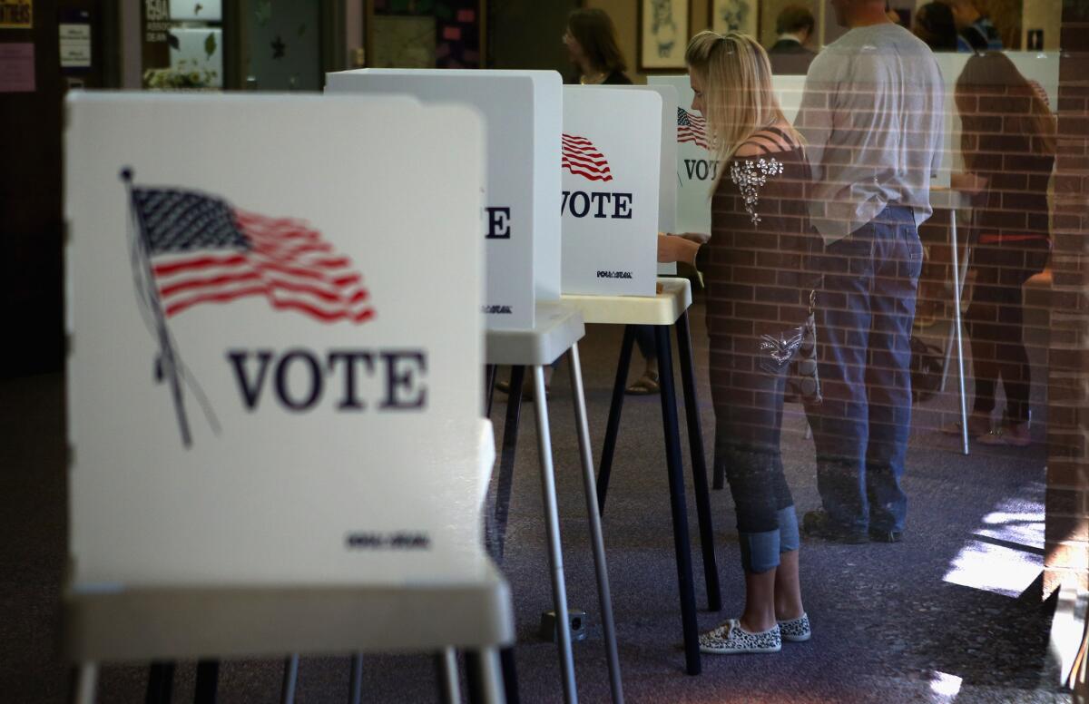 Three NBC/Wall St. Journal surveys this year find a significant increase in the percentage of Americans who call themselves liberals and a decline of conservatives. Above, a polling place in Cedar Falls, Iowa.