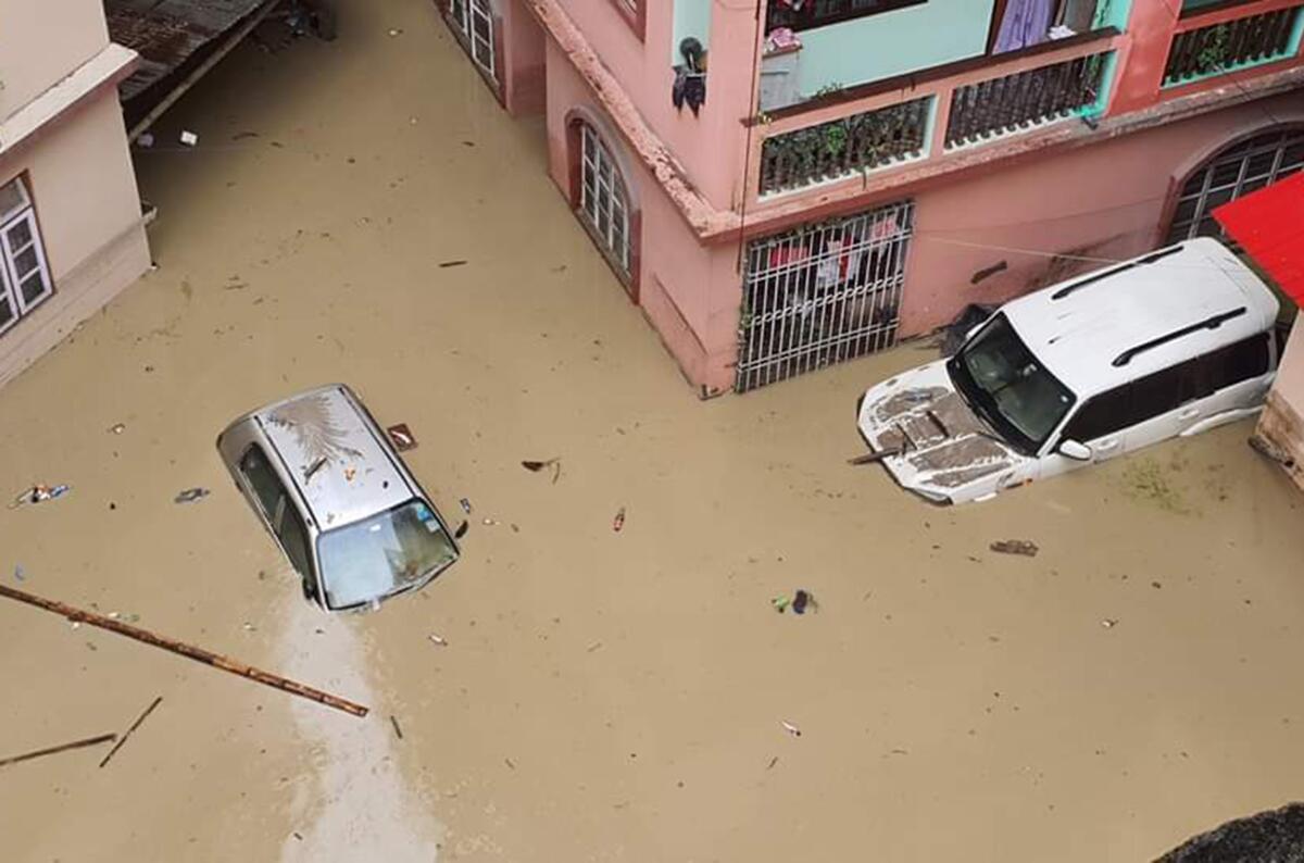 Aerial view of cars partially submerged in floodwaters