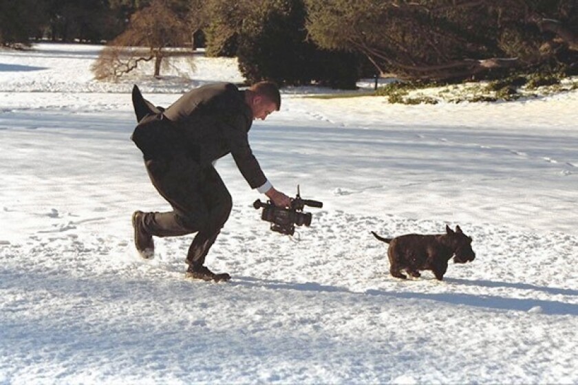 White House communications staffer Sean Newman pursues Barney, President George W. Bush's dog, with a camera during the making of the "Barney Cam II" video on the White House grounds in December 2003. See the full video at the bottom of the story.