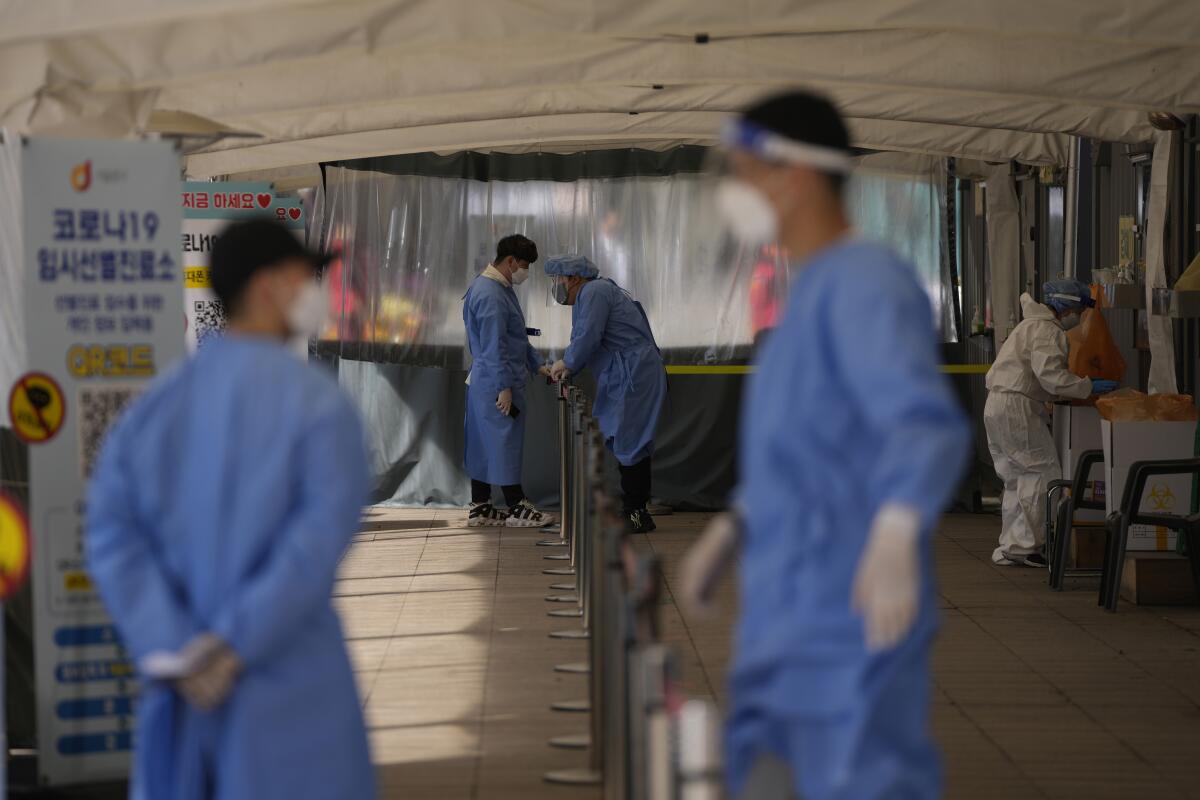Health workers at a temporary coronavirus testing center in Seoul