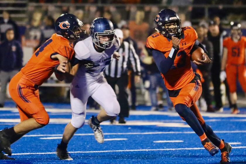 Chaminade quarterback Jaylen Henderson escapes from the pocket in Friday’s Southern Section Division 2 final in West Hills. Sierra Canyon defeated Chaminade, 35-7.