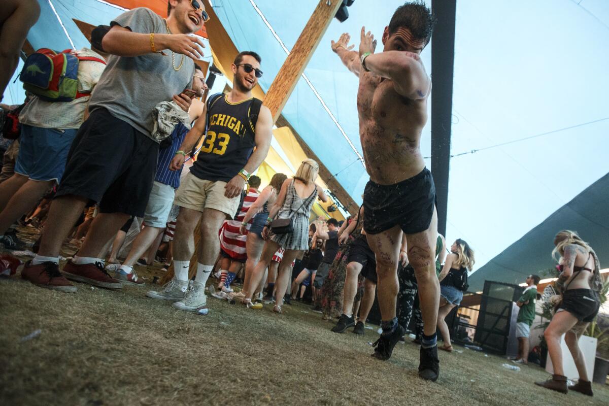 A Coachella attendee launches himself from a pushup into the "dab" while dancing at the 2017 festival.