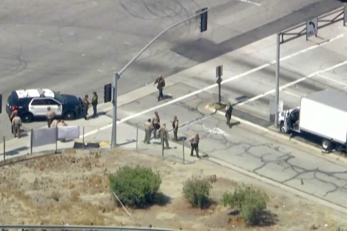 Sheriff's deputies along a road