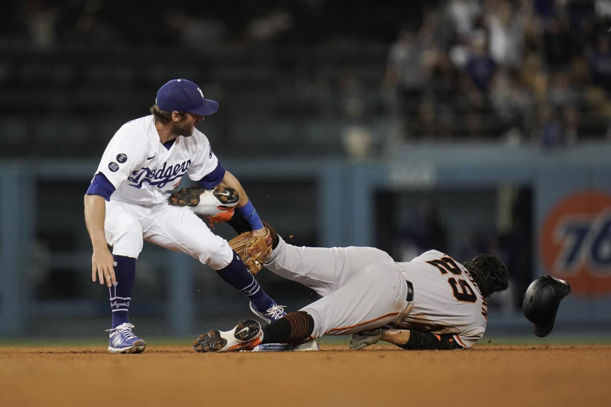The Dodgers' Chris Taylor tags out the Giants' Mike Tauchman as Tauchman tries to take second base June 28, 2021.