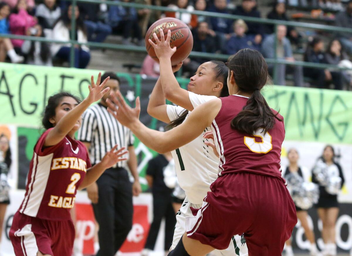 Costa Mesa's Mary Anna Bijanjan (1), pictured driving to the basket in a Jan. 14 game against Estancia, led the Mustangs to a 43-42 win at Calvary Chapel on Thursday.
