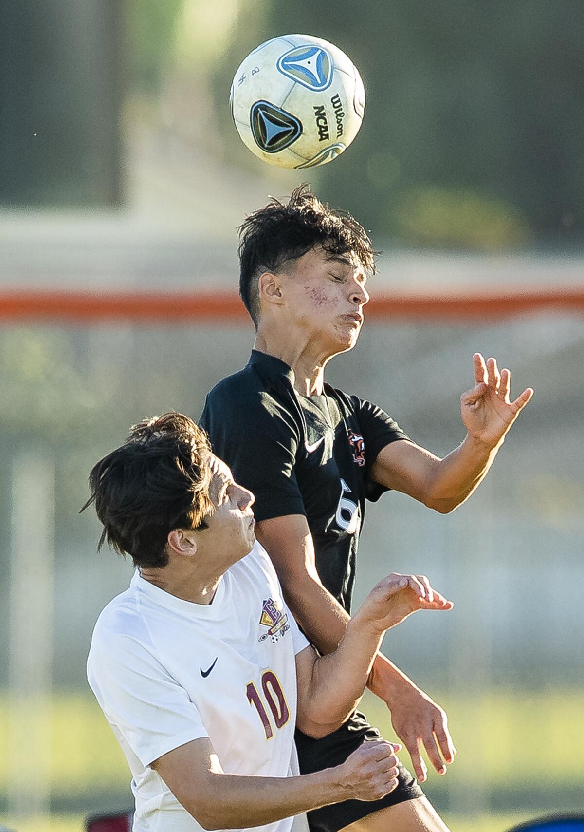 Los Amigos' Izaiah Franco and Esperanza's Jesse Reynoso go up for a header on Friday.