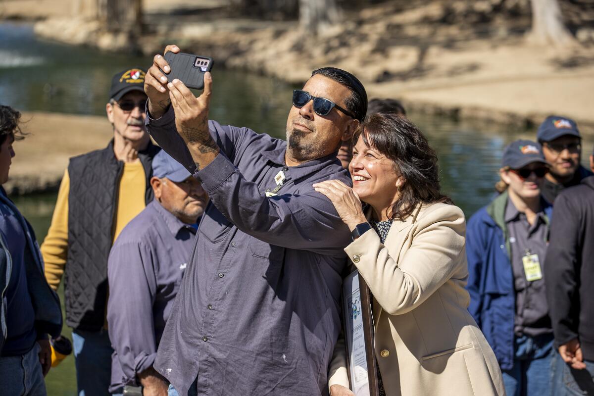 Aaron Trujillo, left, takes a selfie with OC Fair & Event Center Chief Executive Michele Richards at TeWinkle Park on Friday.