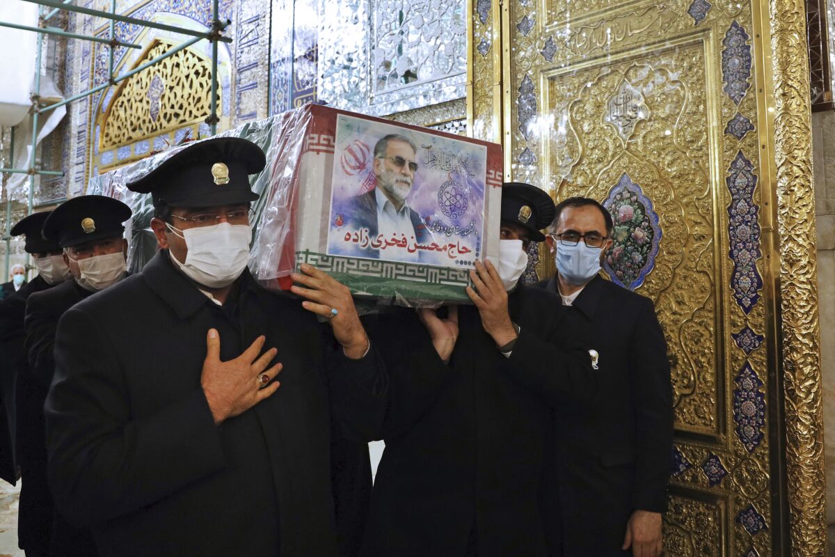 Caretakers from the Imam Reza holy shrine carry the coffin of slain Iranian nuclear scientist Mohsen Fakhrizadeh-Mahabadi. 