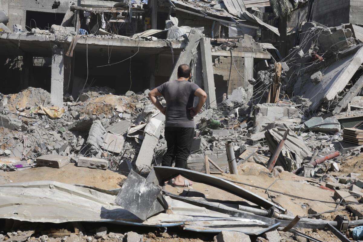 Palestinians look at destruction by Israeli bombardment in the Maghazi refugee camp in the Gaza Strip.