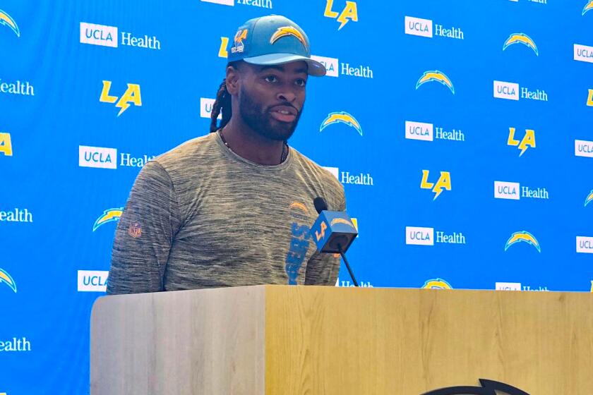 Newly signed Chargers running back Najee Harris speaks at a news conference.
