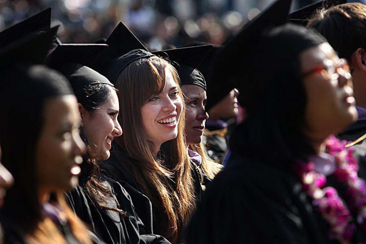 Maria Gomez, center, takes part in graduation ceremonies at UCLA in June 2011. She was receiving her master's degree in architecture.