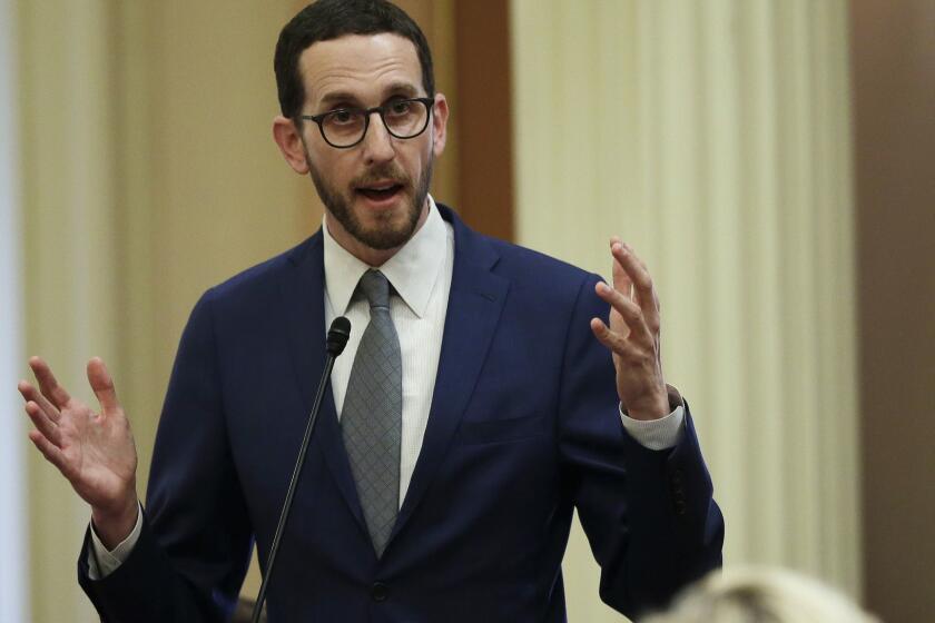 FILE - In this June 28, 2018, file photo, State Sen. Scott Wiener, D-San Francisco, speaks to members of the Senate in Sacramento, Calif. A new California bill would ban doctors from performing treatment or surgery on the genitalia of intersex children unless its medically necessary or the child is old enough to consent. The California Medical Association said it has serious concerns with the legislation because it removes doctors ability to respond to cases on an individual basis. Wiener's bill released Monday, Feb. 4, 2019, is the latest effort in California aimed at giving minors more control over their bodies and gender identities. (AP Photo/Rich Pedroncelli, File)