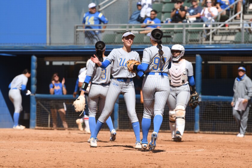 UCLA pitcher Holly Azevedo congratulates teammates Delanie Wisz during her victory over Ole Miss on May 22, 2022.