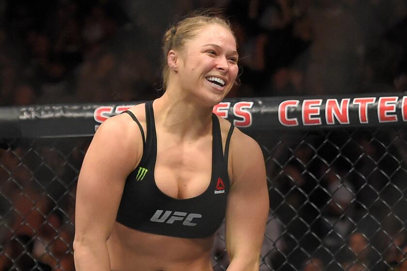 Ronda Rousey smiles after defeating Cat Zingano in a bantamweight title fight at UFC 184 in Los Angeles on Feb. 28.