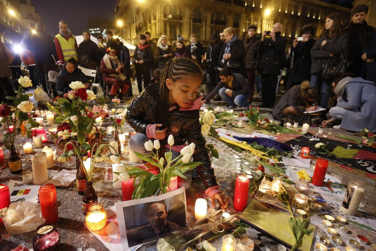 People gather and pay tribute to the many people killed and injured in multiple terrorist attacks across Brussels.