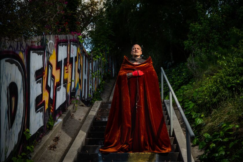 LOS ANGELES, CA --MARCH 27, 2020 -Performance artist Ron Athey, whose work has touched on politics, myth, queerness and the body, is photographed wearing a gown that once belonged to the late Australian-born performance artist Leigh Bowery, on the Micheltorena Stairs, in the Silver Lake neighborhood of Los Angeles, CA, March 27, 2020, and is one of many L.A. artists dealing with the coronavirus pandemic and trying to keep creating as restrictions on daily life have increased. Athey is using the quarantine time to work on a retrospective that is currently scheduled to open in the fall at Participant Inc. in New York City, and will later travel to the Institute of Contemporary Art, Los Angeles.(Jay L. Clendenin / Los Angeles Times)