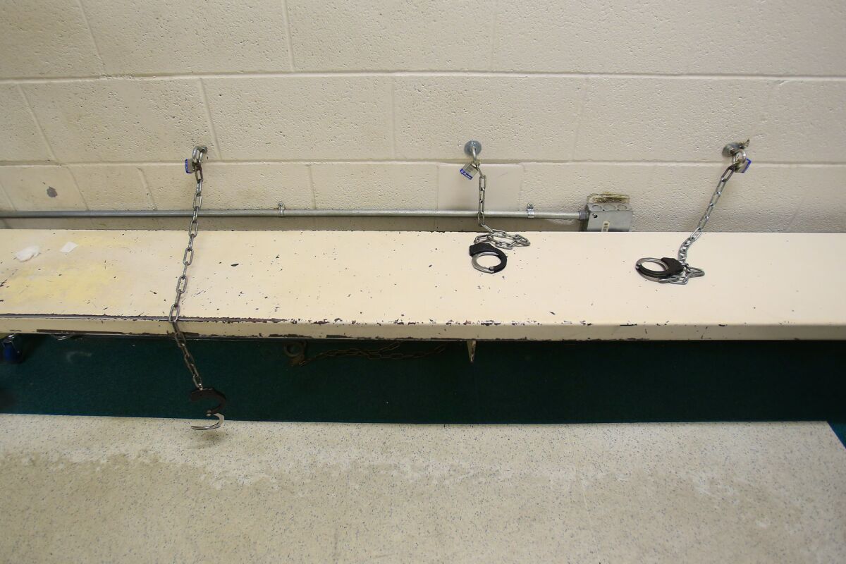 Handcuffs attached to benches at a temporary holding area for the intake section at Downtown Central Jail. 