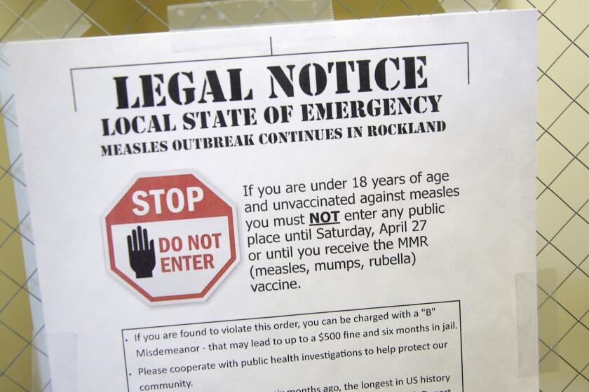 FILE - This Wednesday, March 27, 2019 file photo shows a sign explaining the local state of emergency because of a measles outbreak at the Rockland County Health Department in Pomona, N.Y. Measles is spread through the air when an infected person coughs or sneezes. It's so contagious that 90 percent of people who aren't immunized are infected if exposed to the virus, according to the Centers for Disease Control and Prevention. (AP Photo/Seth Wenig)