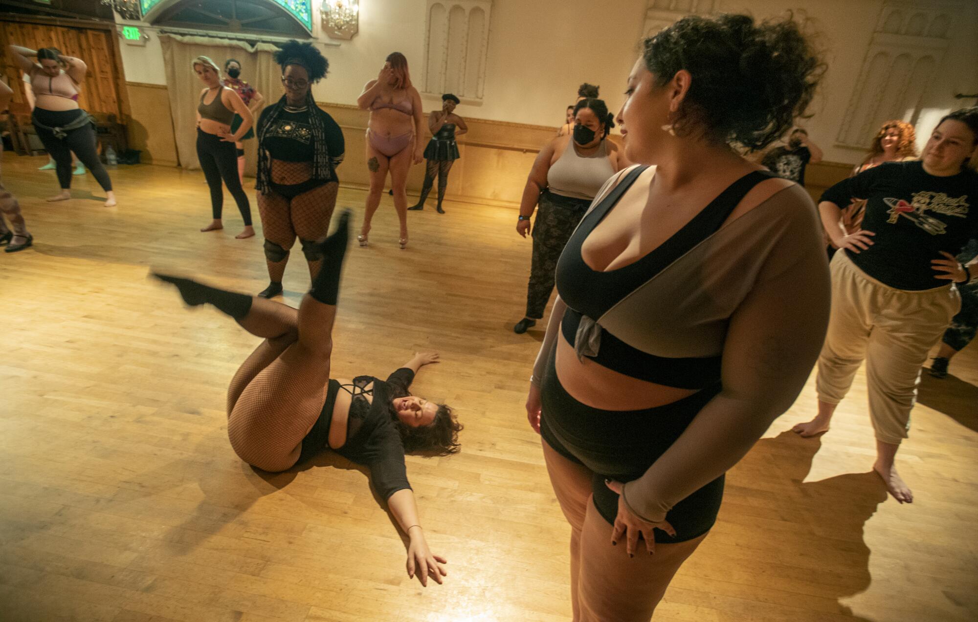 Dancers watch an instructor during a workshop.