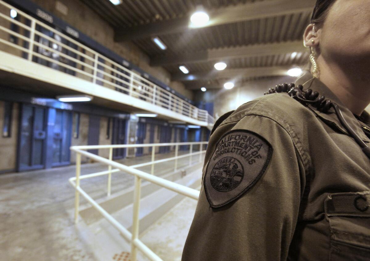 A corrections officer is shown in one of the housing units at Pelican Bay State Prison.