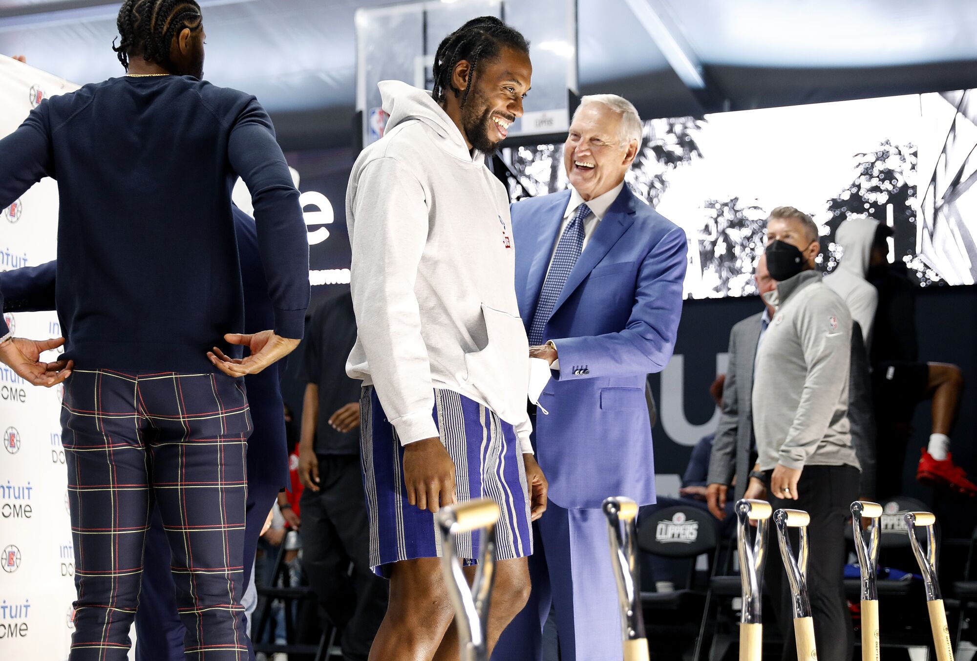 Clippers star Kawhi Leonard and team consultant Jerry West share a laugh.
