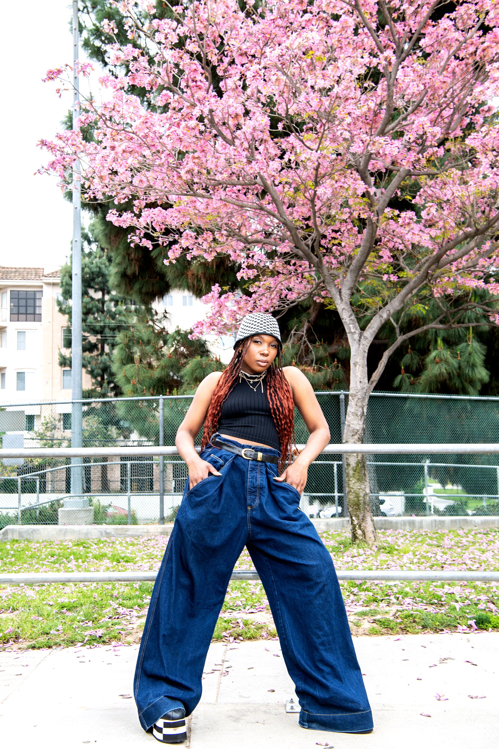 Danasia Sutton in Sorella top, Martine Rose jeans, Comme Des Garçons x Nike platform sneakers, Urban Outfitters hat.