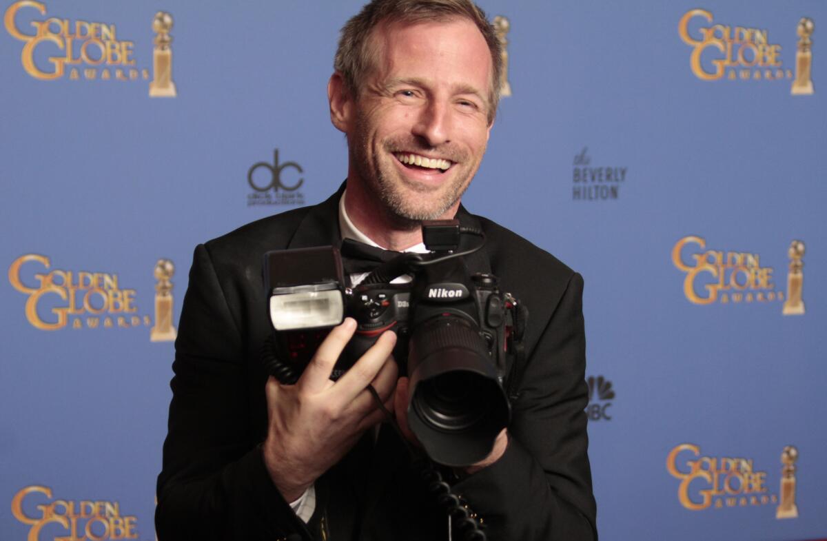 Spike Jonze with a photographer's camera in the deadline room after winning the Golden Globe for screenplay for the movie "Her" at the 71st Annual Golden Globe Awards show at the Beverly Hilton Hotel on Jan. 12, 2014.