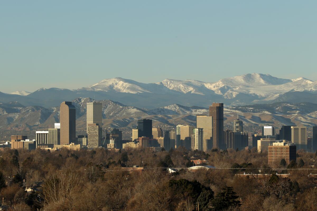 The Rocky Mountains rise beyond the Denver skyline.