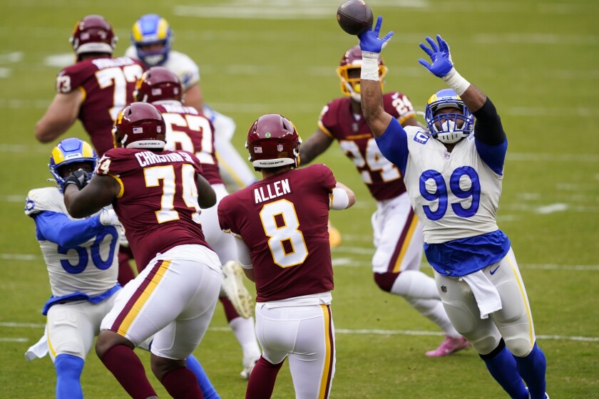 Aaron Donald (99) puts pressure on the Washington Football Team's Kyle Allen.