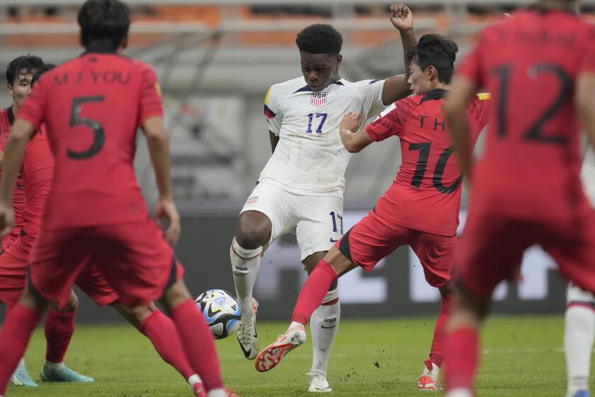 FILE - United States' Keyrol Figueroa, center, battles for the ball against South Korea's Jin Taeho during their FIFA U-17 World Cup Group E soccer match at Jakarta International Stadium in Jakarta, Indonesia, on Nov. 12, 2023. United States youth international Keyrol Figueroa has signed a pro contract with Liverpool, the Premier League club said Tuesday. The 17-year-old Figueroa has impressed since moving to the Merseyside club when he was 14 and has consistently scored at different age levels. Liverpool described him in a statement as a “prolific goalscorer.” (AP Photo/Dita Alangkara)