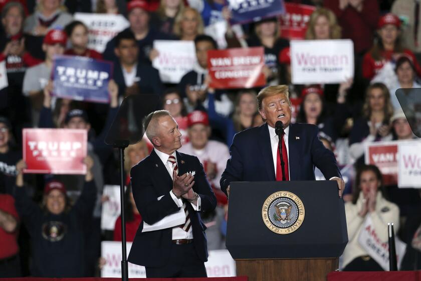 President Donald Trump speaks at a campaign rally Tuesday, Jan. 28, 2020, in Wildwood, N.J., as Rep. Jeff Van Drew, R-N.J., listens. (AP Photo/Mel Evans)