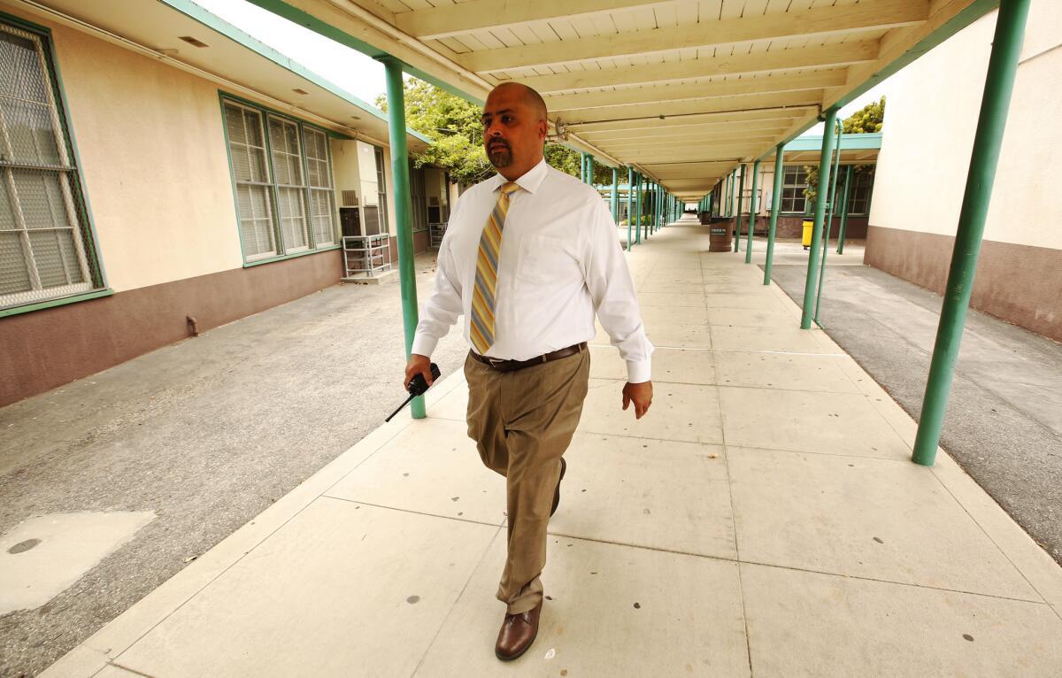 Peter Benefiel, Principal at Daniel Webster Middle School, walks on the school grounds Wednesday May 17, 2017. The conflict between charters and traditional public schools was the crux of yesterday's election.