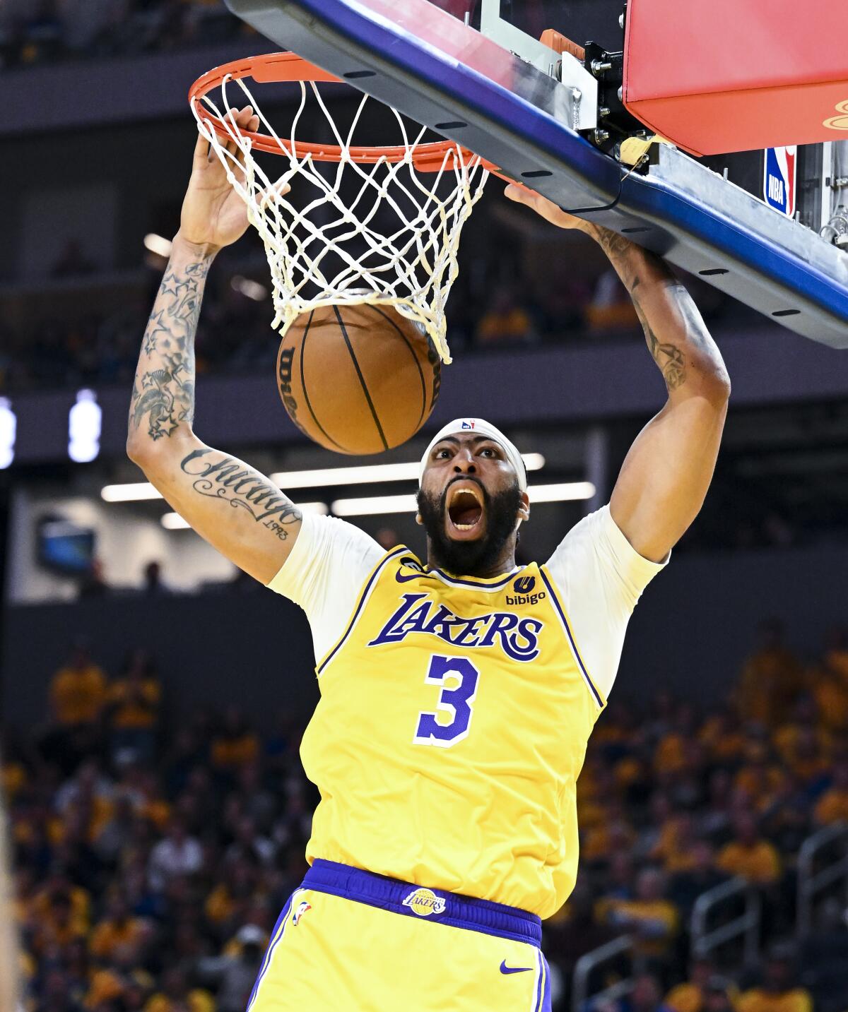 Lakers forward Anthony Davis yells as he dunks during the first quarter of Game 5.