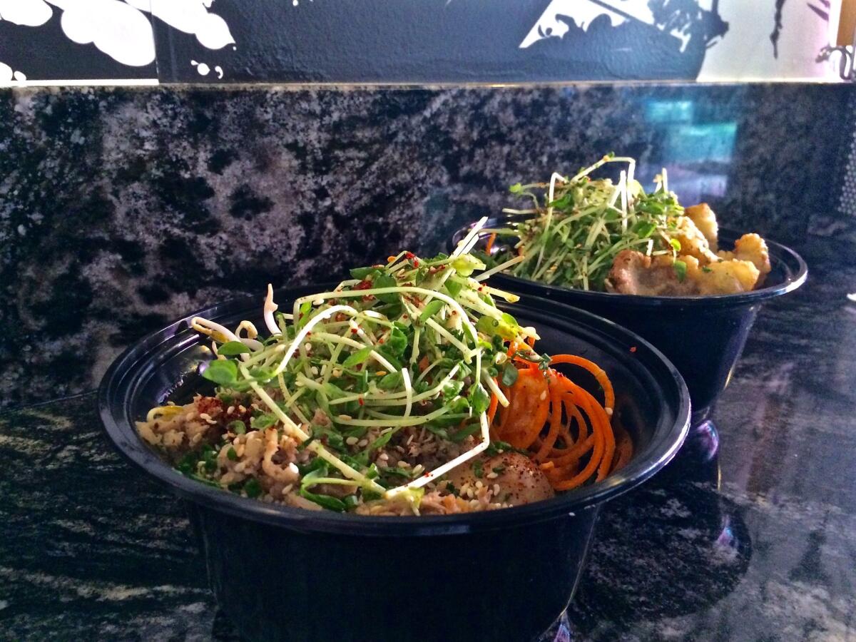 Ramen Champ's Coachella bowls, filled with rice and bacon chashu, and fried mushrooms and noodles.