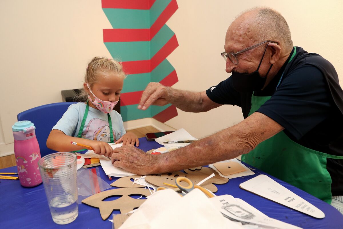 Kate Dell and her grandfather Tom Johnson participate in a character clock-building workshop.