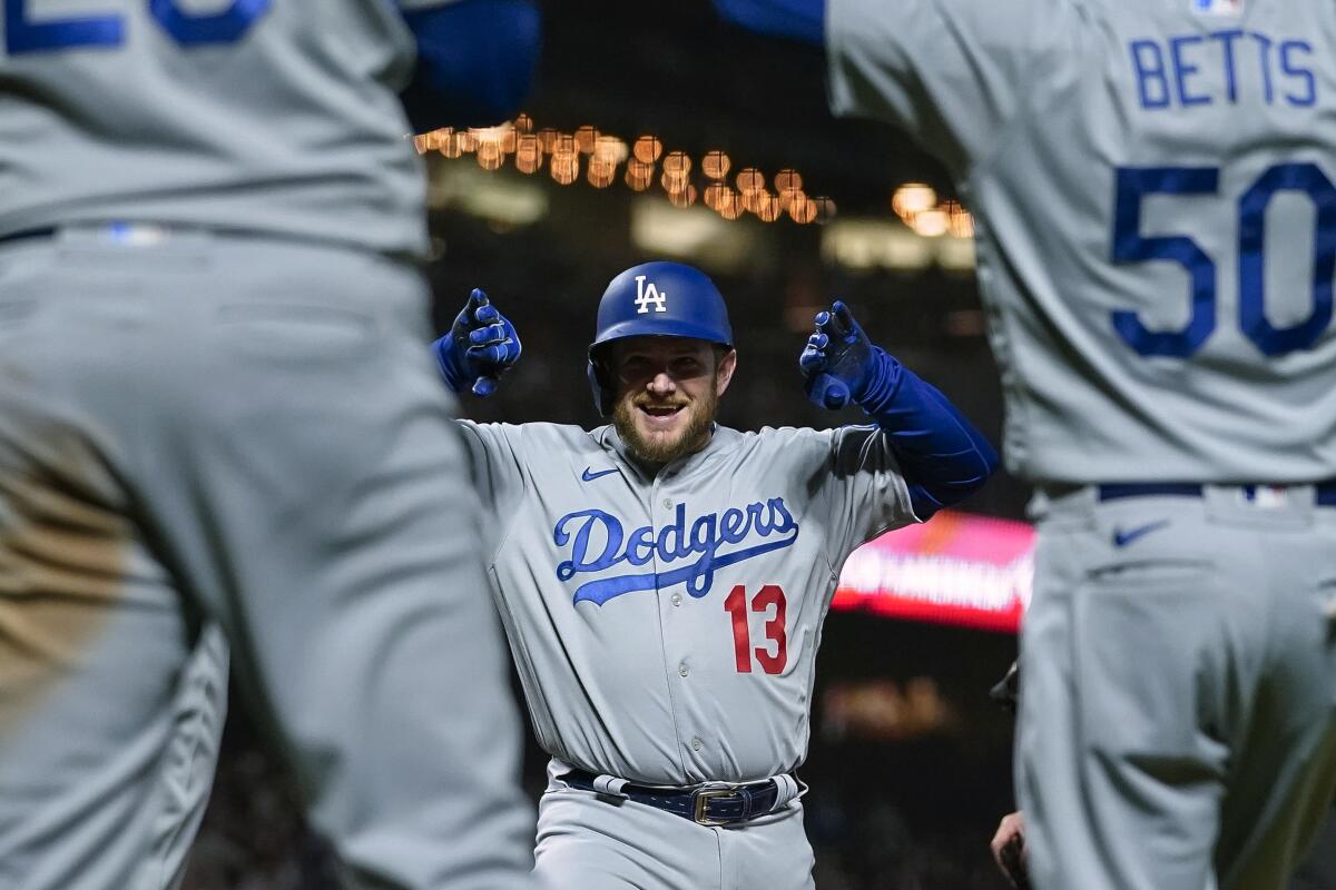 The Dodgers' Max Muncy celebrates with teammates after hitting a three-run home run against the San Francisco Giants 