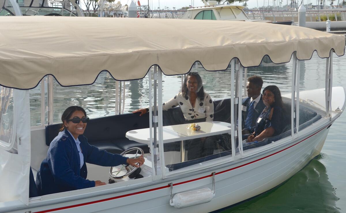 Technical Sgt. Natasha Burroughs takes Royel Augustine and her family for a boat ride.