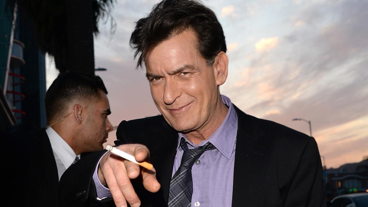 Charlie Sheen, shown at the "Scary Movie 5" premiere in April 2013, was accused of behaving badly at a recent trip to the dentist, but his rep and lawyer say the allegations are false.
