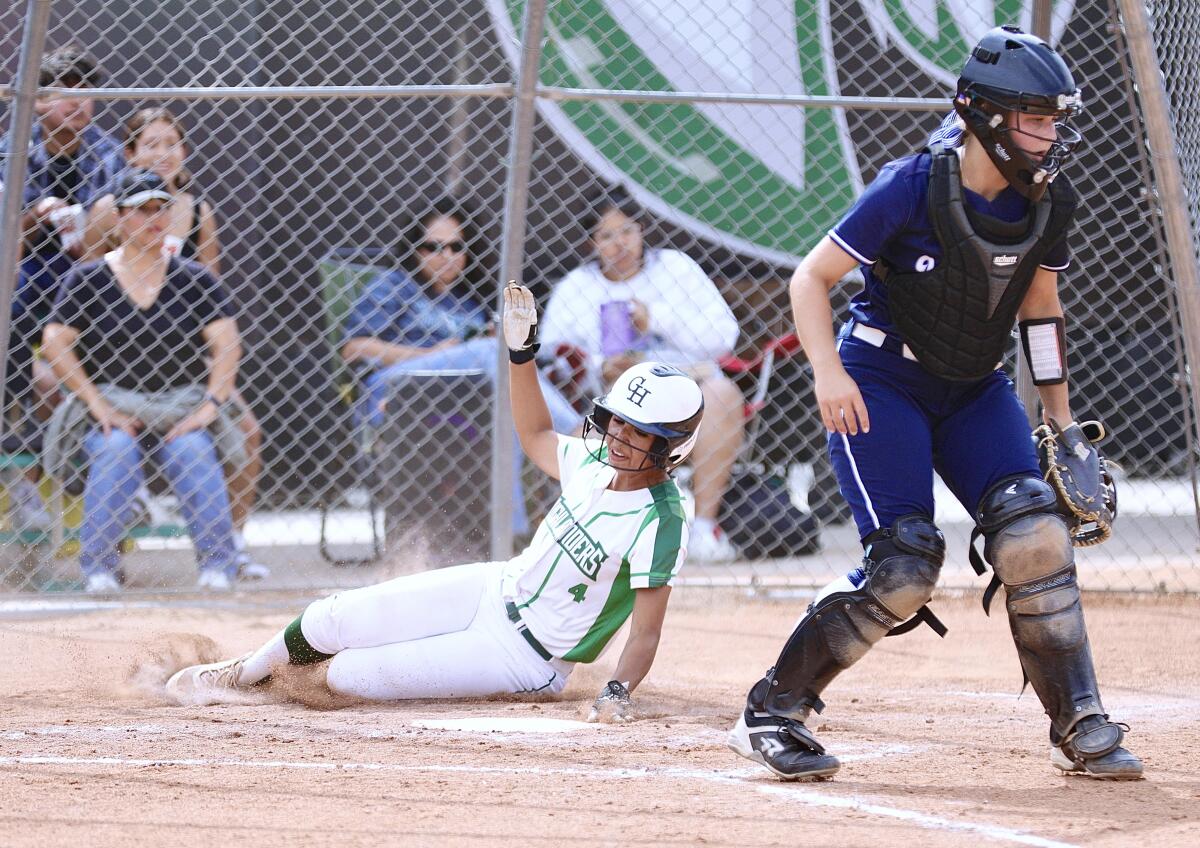 Samantha Esparza slides home in the third inning of Granada Hills’ 19-0 victory over Venice.