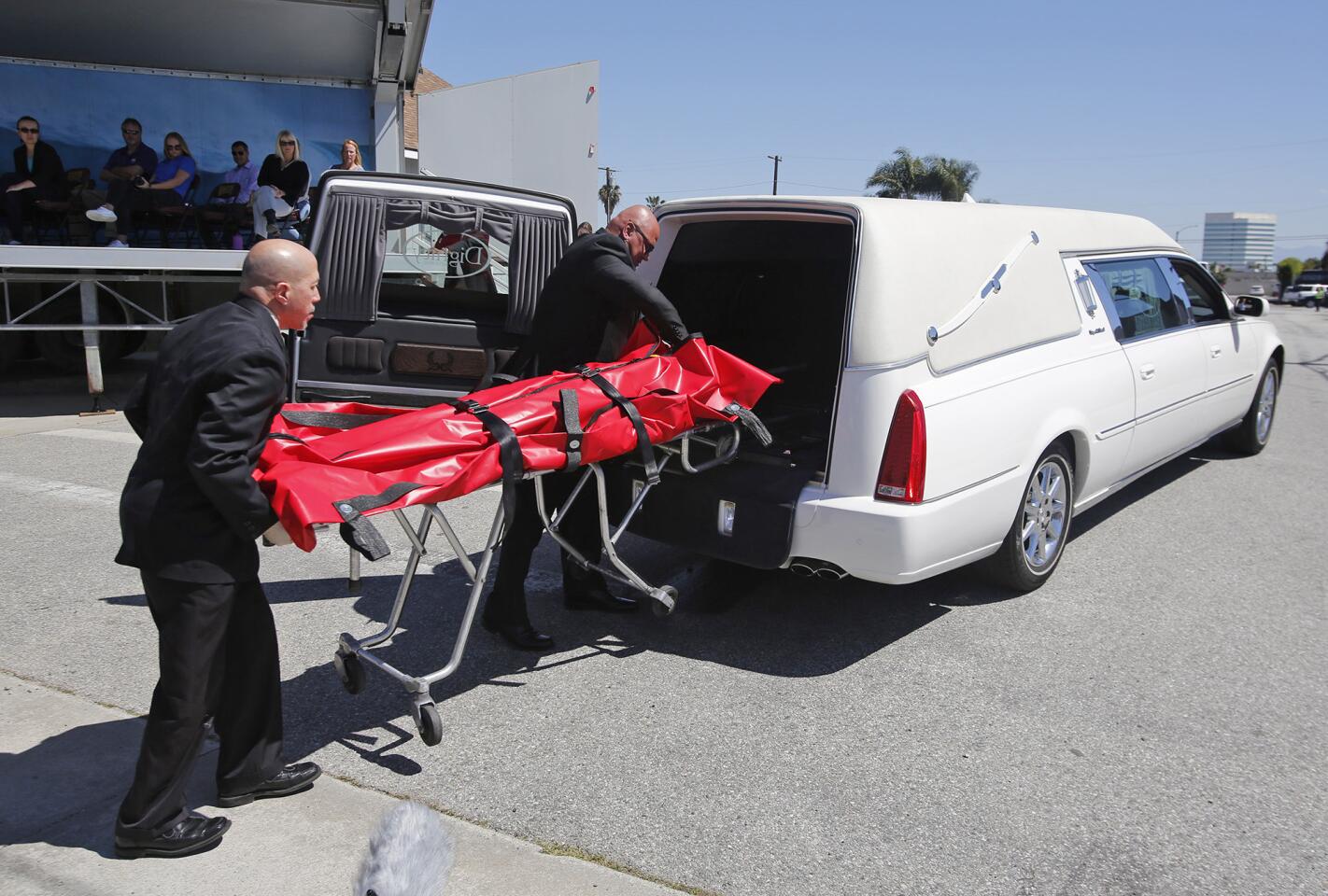 Local coroners take away a mock fatality during a live accident reenactment for the "Every 15 Minutes" program to emphasize the dangers of driving under the influence to students at Ocean View High School in Huntington Beach on Monday.