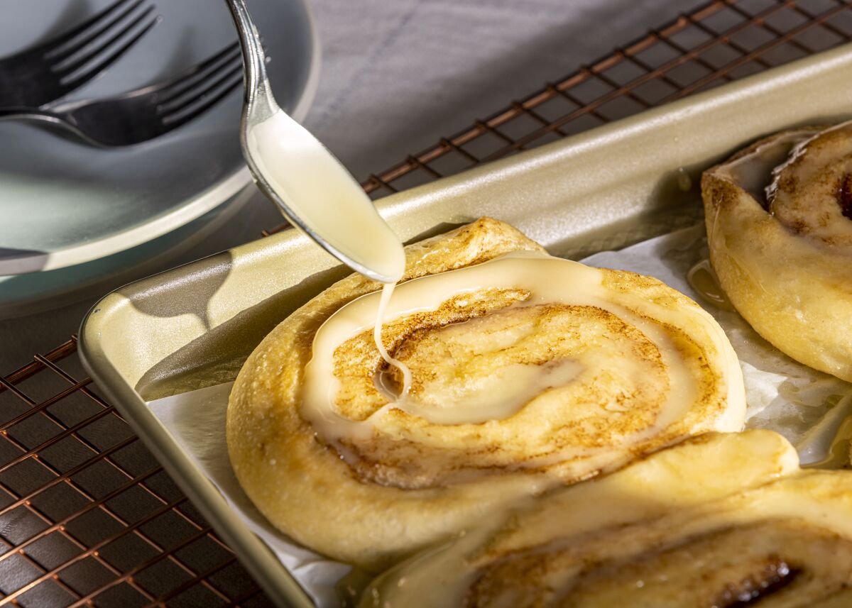 Glaze is added to honey buns.