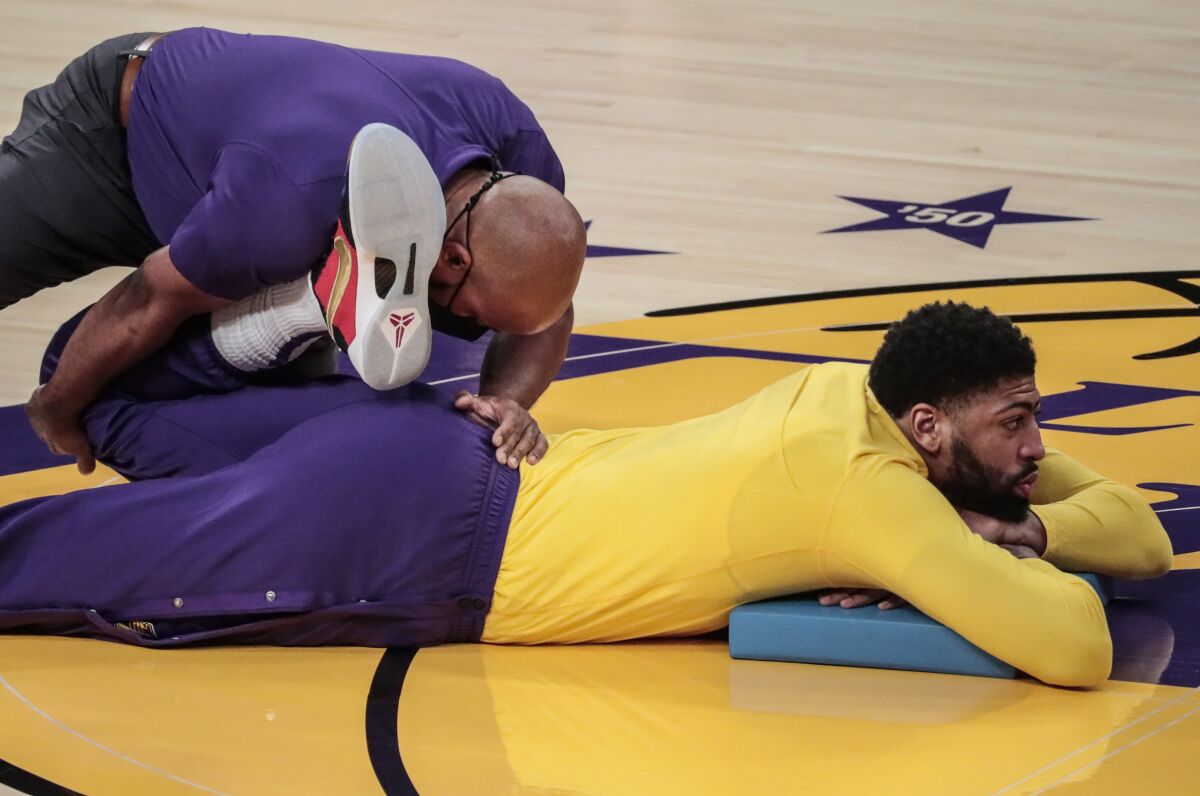 Anthony Davis stretches on the court before a game this season.