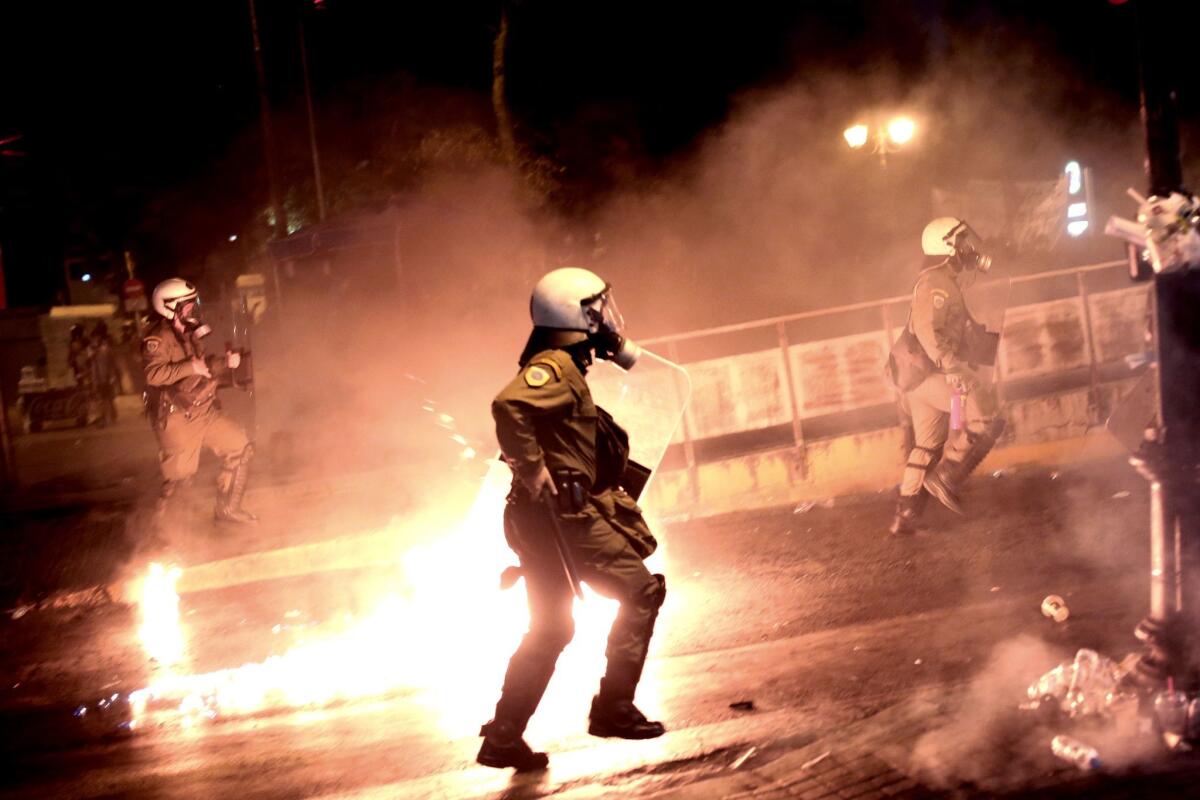 Riot police run after protesters throwing gasoline bombs in central Athens during an anti-austerity demonstration on July 15.