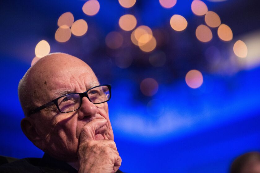 Rupert Murdoch, chairman of News Corp., listens as U.S. President Barack Obama, not pictured, speaks at the Wall Street Journal CEO Council annual meeting at the Four Seasons Hotel in Washington, D.C., on Tuesday, Nov. 19, 2013. Obama said the U.S. can cut the deficit and spur economic growth at the same time, and that short-term deficits aren't the nation's primary fiscal concern. Photographer: Drew Angerer/Bloomberg via Getty Images